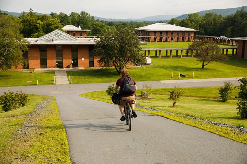 Landmark College student riding a bicycle on campus.