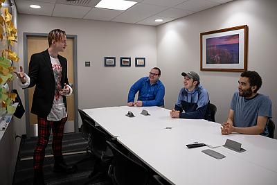 Student presenting at White Board to group of students and faculty